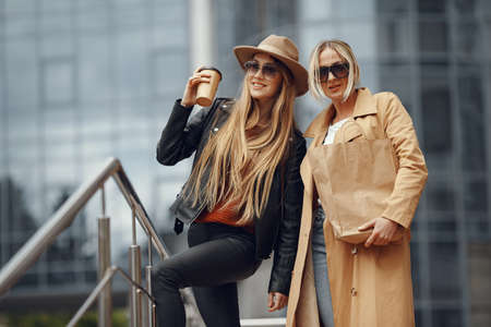 Two women standing in a autumn cityの写真素材