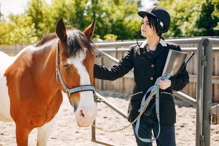 Beautiful woman standing with a horse