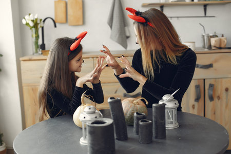 Mother with daughter in a halloween costume and makeup