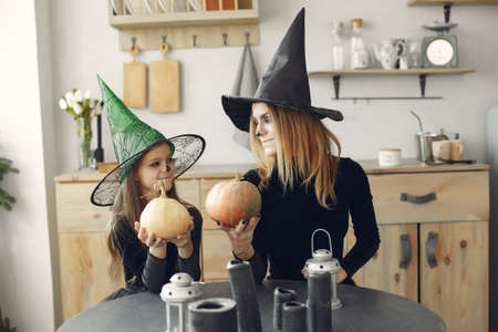 Mother with daughter in a halloween costume and makeupの写真素材