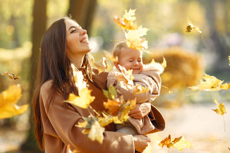 Cute and stylish family in a autumn parkの写真素材