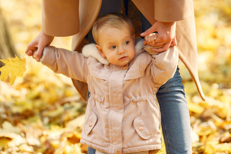 Cute and stylish family in a autumn park