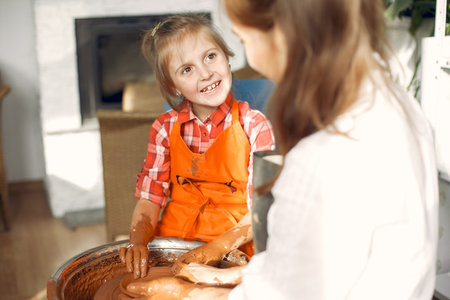 People making a vaze from a clay on a potterys machineの写真素材