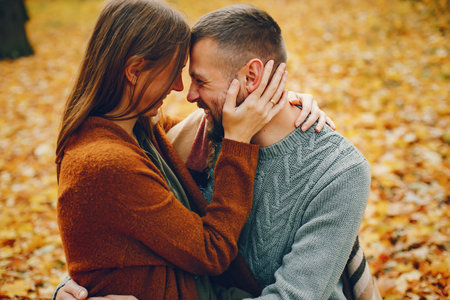 Beautiful couple spend time in a autumn park