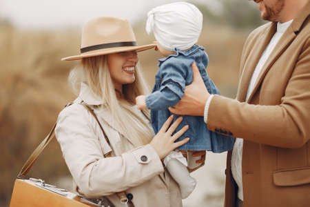 Stylish family walking on a autumn fieldの写真素材