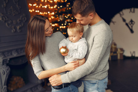 Family at home near christmas tree