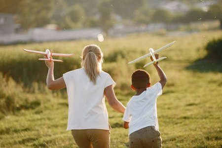 Multi-racial family playing in a summer parkの写真素材