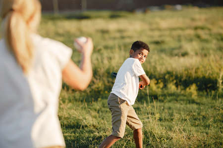 Multi-racial family playing in a summer parkの写真素材