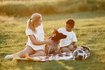 Multi-racial family playing in a summer parkの写真素材