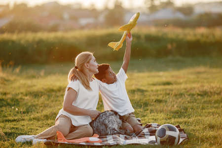 Multi-racial family playing in a summer parkの写真素材