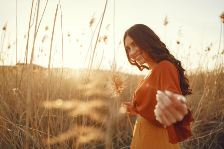 Stylish woman spending time in a summer field