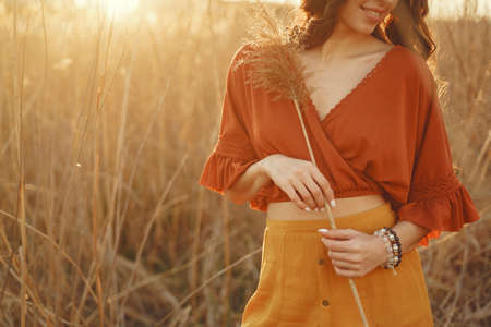 Stylish woman spending time in a summer fieldの写真素材