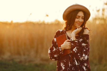 Stylish woman spending time in a summer fieldの写真素材
