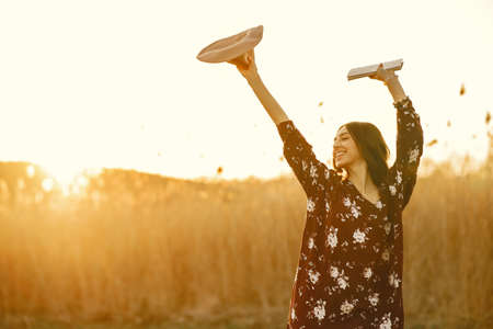 Stylish woman spending time in a summer fieldの写真素材