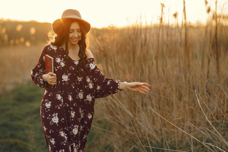 Stylish woman spending time in a summer field