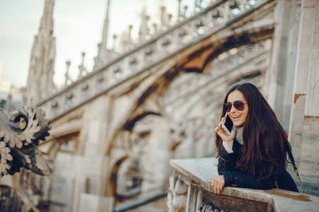 girl using her phone while exploring Milan Italyの写真素材
