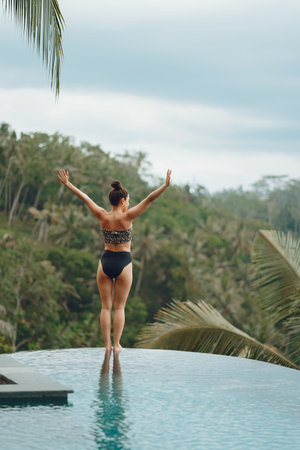 Woman in a swimming pool on a jungle view