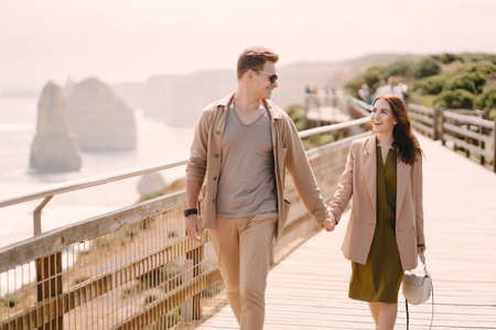 Couple on vacation wlking on a bridgeの写真素材