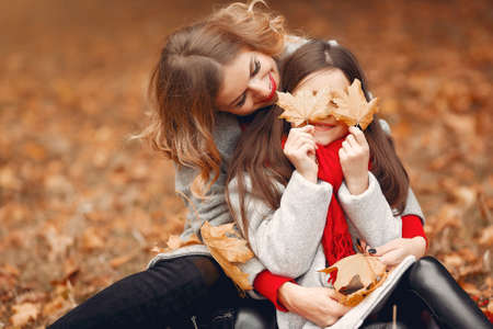 Cute and stylish family in a autumn parkの写真素材