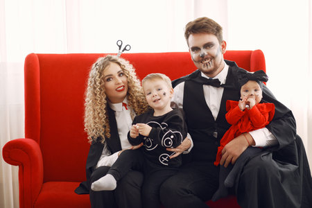 Family in costumes getting ready for halloween at home