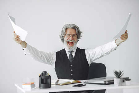 Handsome pensive mature businessman in the officeの写真素材