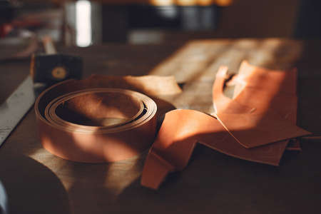 Man in a studio creates leather wareの写真素材