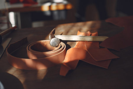 Man in a studio creates leather ware