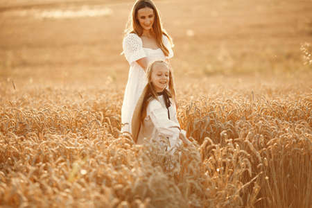 Mother with daughter in a wheat fieldの写真素材