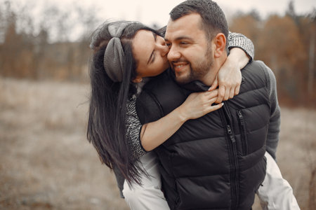 Beautiful couple spend time in a spring field