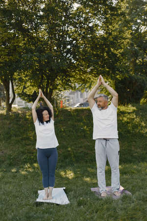 Happy elderly senior couple doing yogaの写真素材