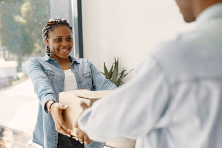 Couple with boxes moving into new home smilingの写真素材