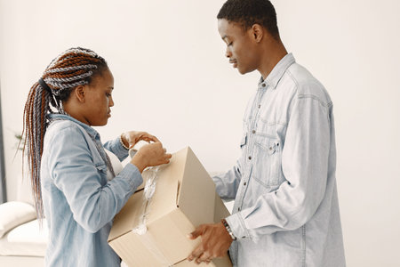 Couple with boxes moving into new home smiling