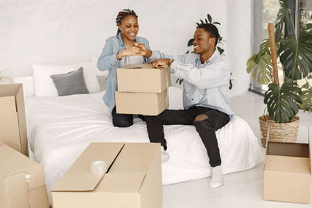 Couple with boxes moving into new home smilingの写真素材