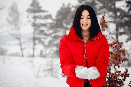 Elegant and young girl in a winter parkの写真素材