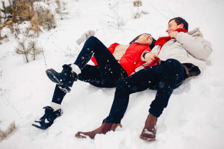 Loving couple walking in a winter parkの写真素材