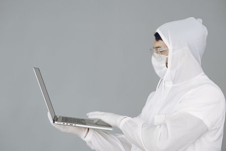 Man in protective suit and glasses in studio