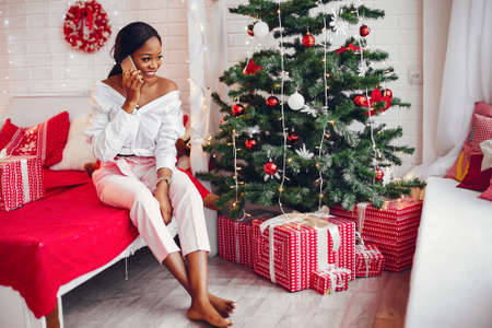 Elegant black girl in the Christmas decorationsの写真素材