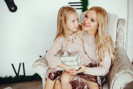 Mother with cute daughter at home