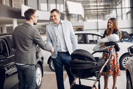 Family with little son in a car salon