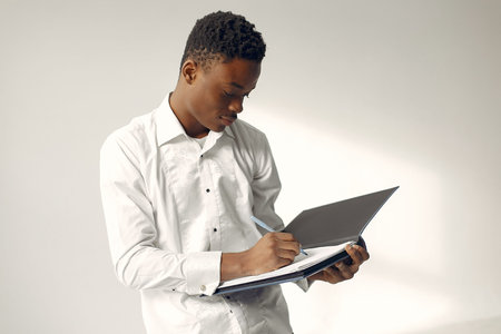 Handsome black man standing on a white background