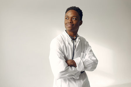 Handsome black doctor in a white uniform with a stethoscope