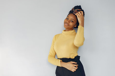 Cute black woman standing on a white background