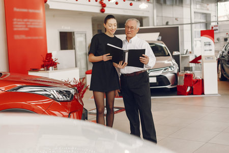 Stylish and elegant old man in a car salon
