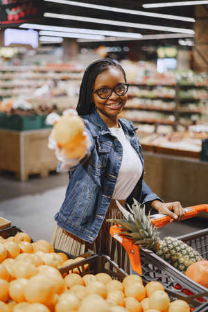 Woman shopping vegetables at the supermarketの写真素材