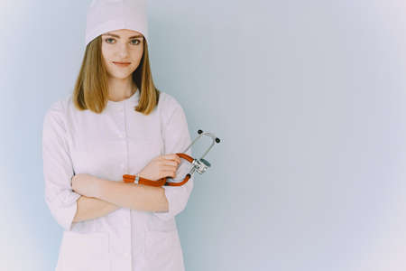 Woman doctor with white coat in hospitalの写真素材