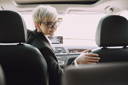 Businesswoman sitting inside a car