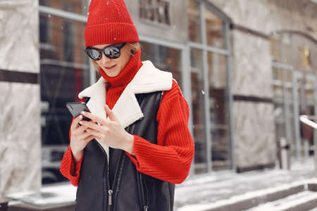 Winter time in big city of charming girl standing on streetの写真素材