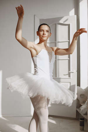 Ballerina posing in front of white backgroundの写真素材