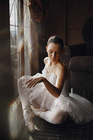 Ballerina posing in front of white backgroundの写真素材