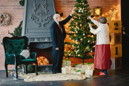 An elegant old couple are celebrating Christmasの写真素材